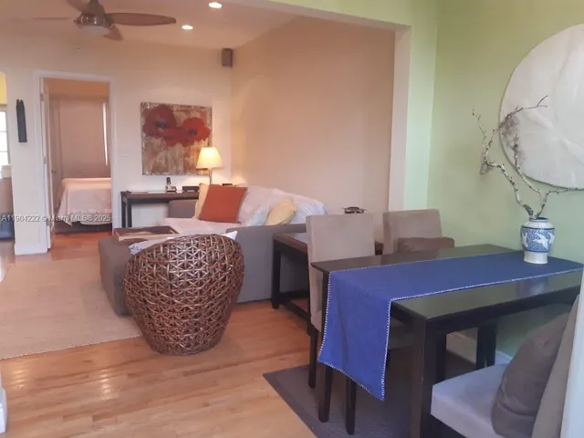 a living room with furniture a rug and a chandelier