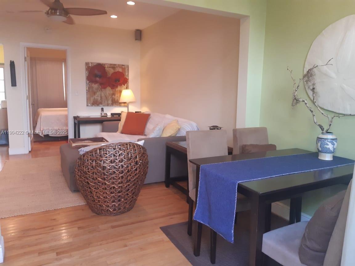 744 Lenox Avenue, Unit 3 Miami Beach, FL 33139 - Photo 3 of 13 a living room with furniture a rug and a chandelier