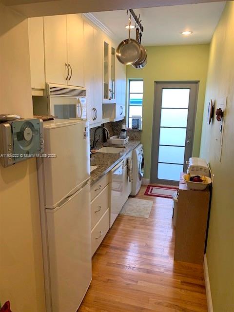 744 Lenox Avenue, Unit 3 Miami Beach, FL 33139 - Photo 4 of 13 a kitchen with sink a refrigerator and wooden floor