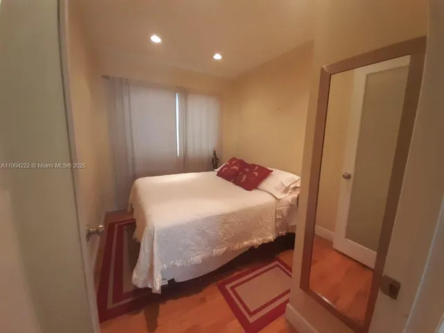 a bedroom with a bed and a mirror