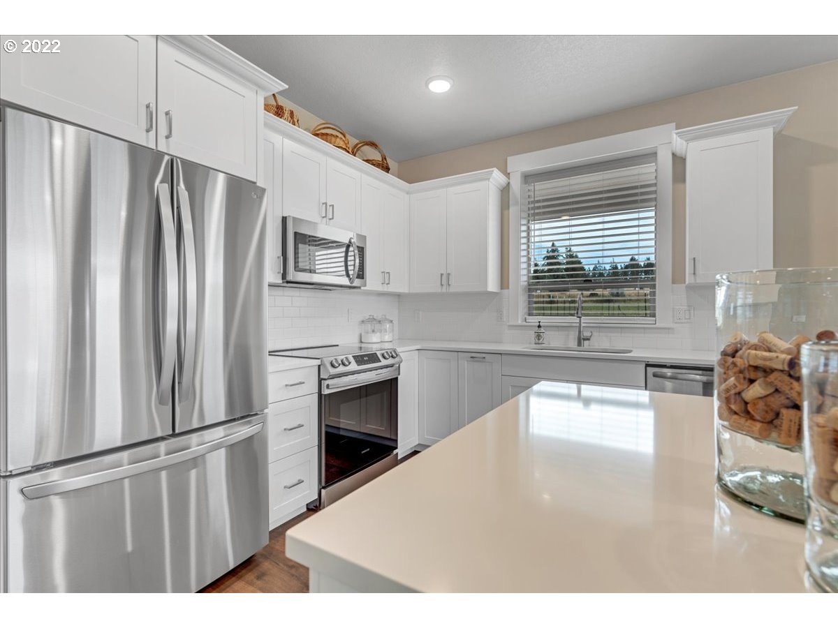 18809 South Kimball Road Oregon City, OR 97045 - Photo 26 of 32 a kitchen with stainless steel appliances a refrigerator sink and stove