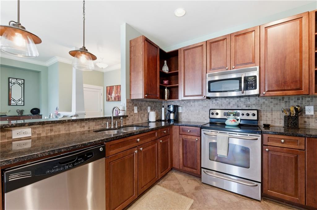 117 South Bay Road, Unit 402 Eatonton, GA 31024 - Photo 33 of 48 a kitchen with stainless steel appliances a stove sink and cabinets