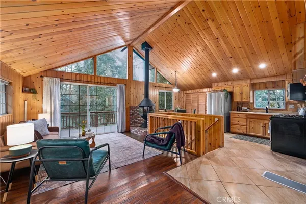 a living room with furniture a wooden floor and next to a large window