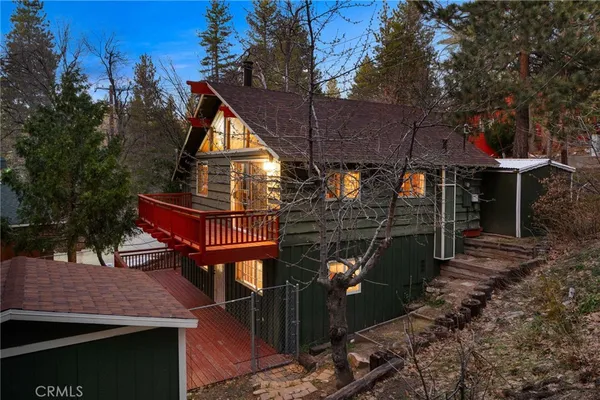 a view of house with backyard outdoor seating and trees