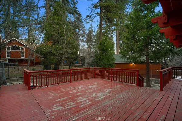 a view of backyard with deck and outdoor seating