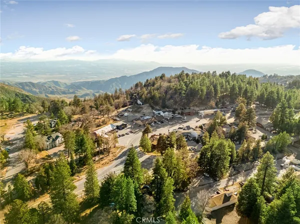 an aerial view of a residential houses with yard