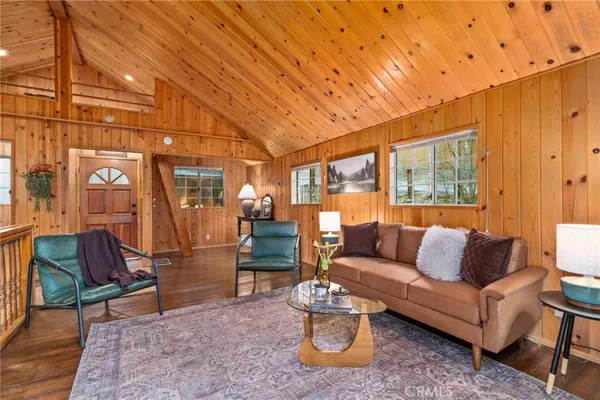 a living room with furniture and a floor to ceiling window