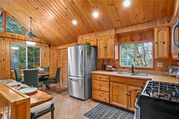 a kitchen with stainless steel appliances a refrigerator and a stove top oven