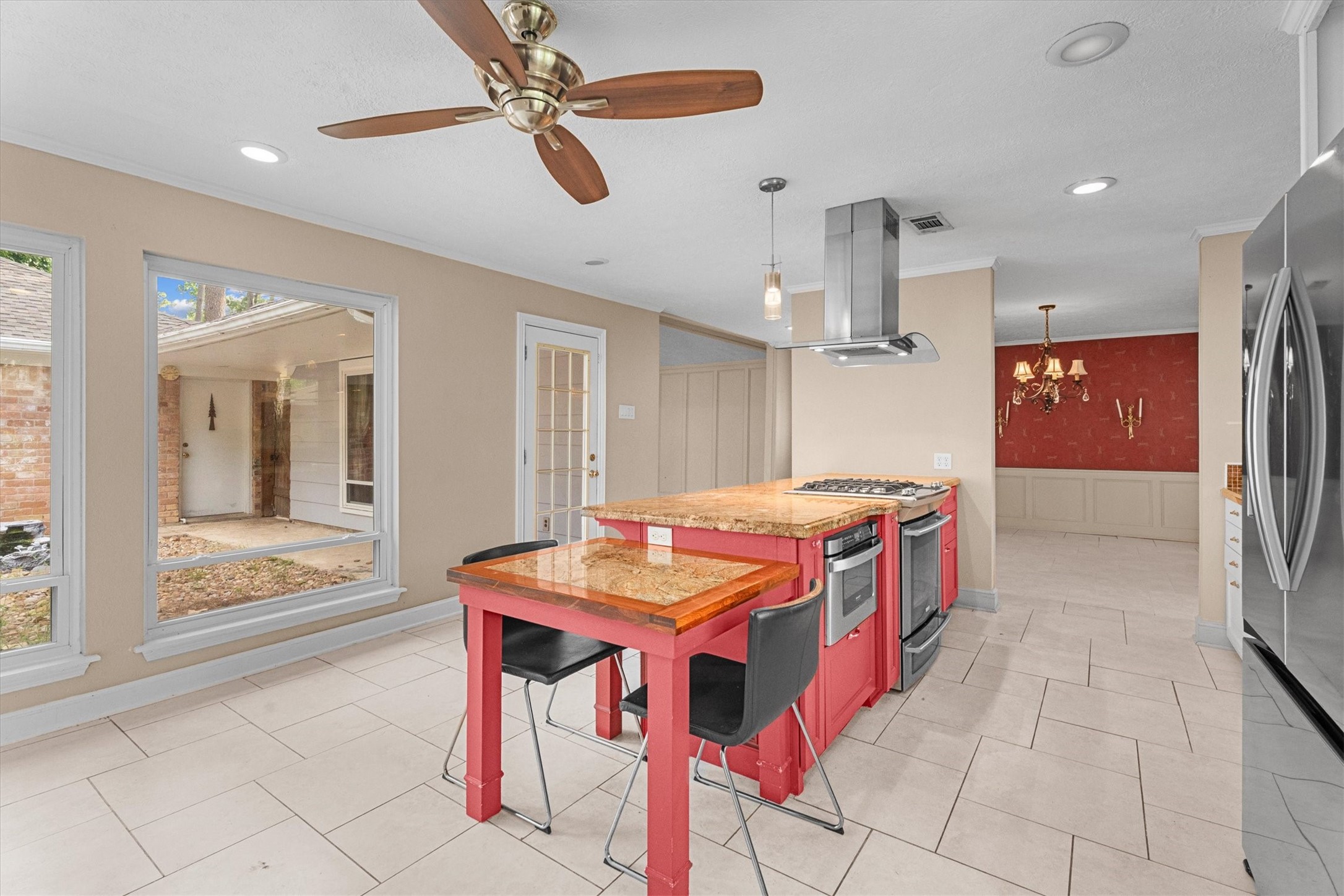 25319 Old Carriage Lane Spring, TX 77373 - Photo 14 of 35 a open kitchen with stainless steel appliances kitchen island granite countertop a table and chairs