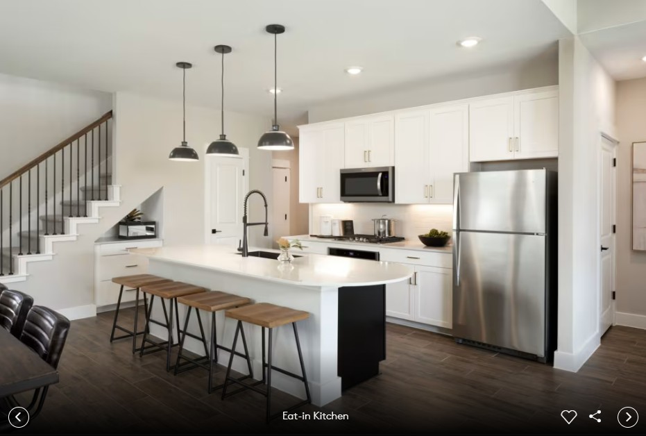 345 Foresail Road Leander, TX 78641 - Photo 4 of 7 a kitchen with stainless steel appliances a refrigerator a stove a sink dishwasher and white cabinets with wooden floor