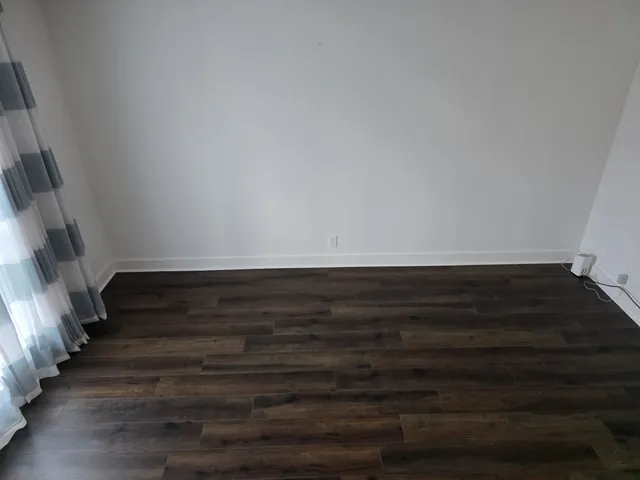 a view of room with wooden floor