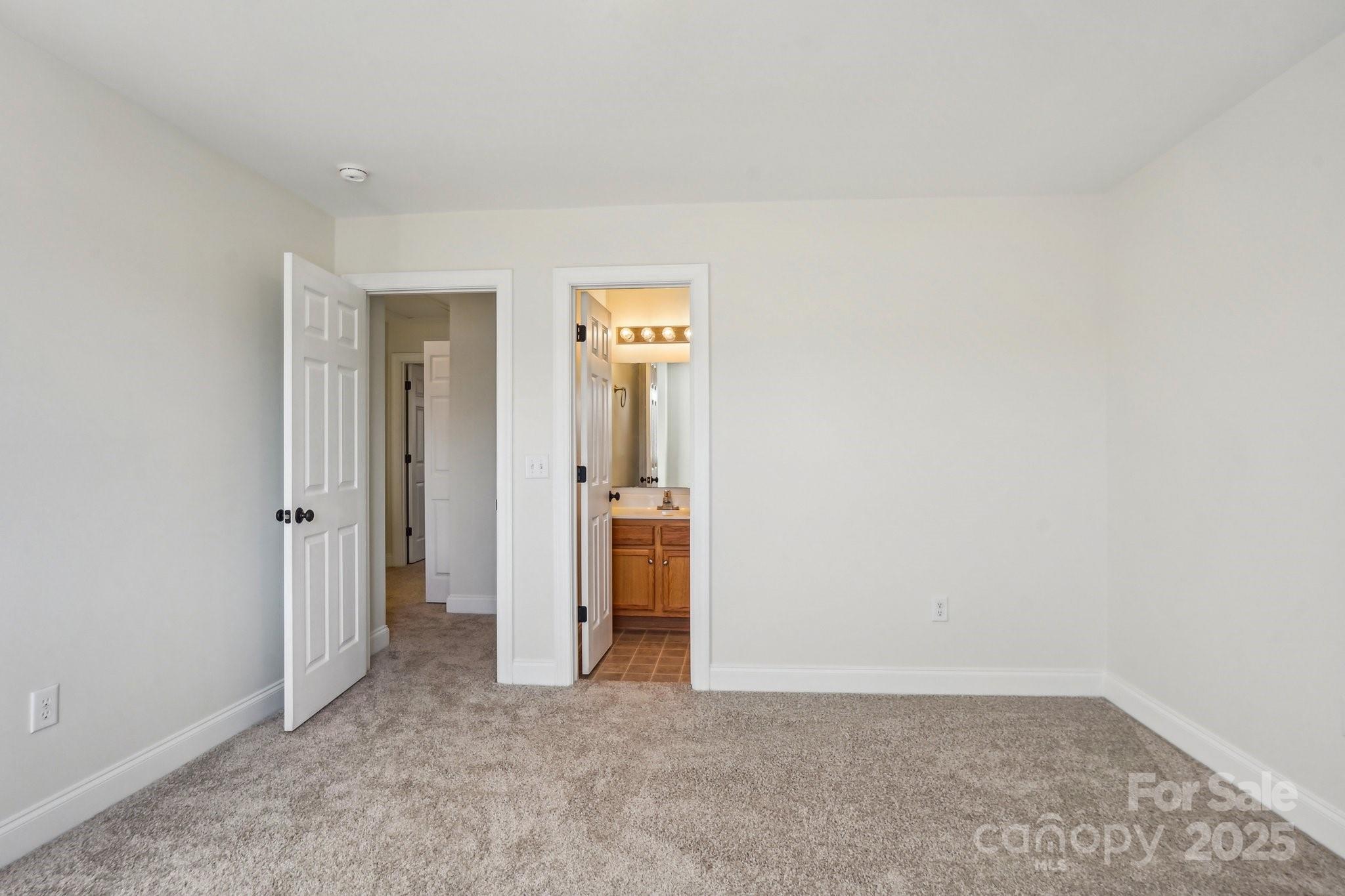 127 High Ridge Road Mooresville, NC 28117 - Photo 15 of 34 an empty room with closet and mirror