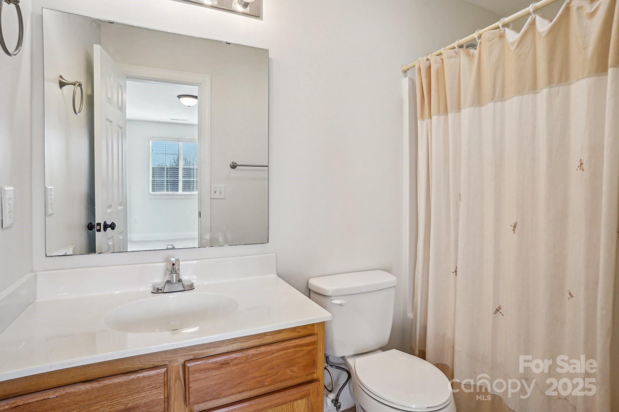 127 High Ridge Road Mooresville, NC 28117 - Photo 16 of 34 a bathroom with a sink a toilet and shower curtain