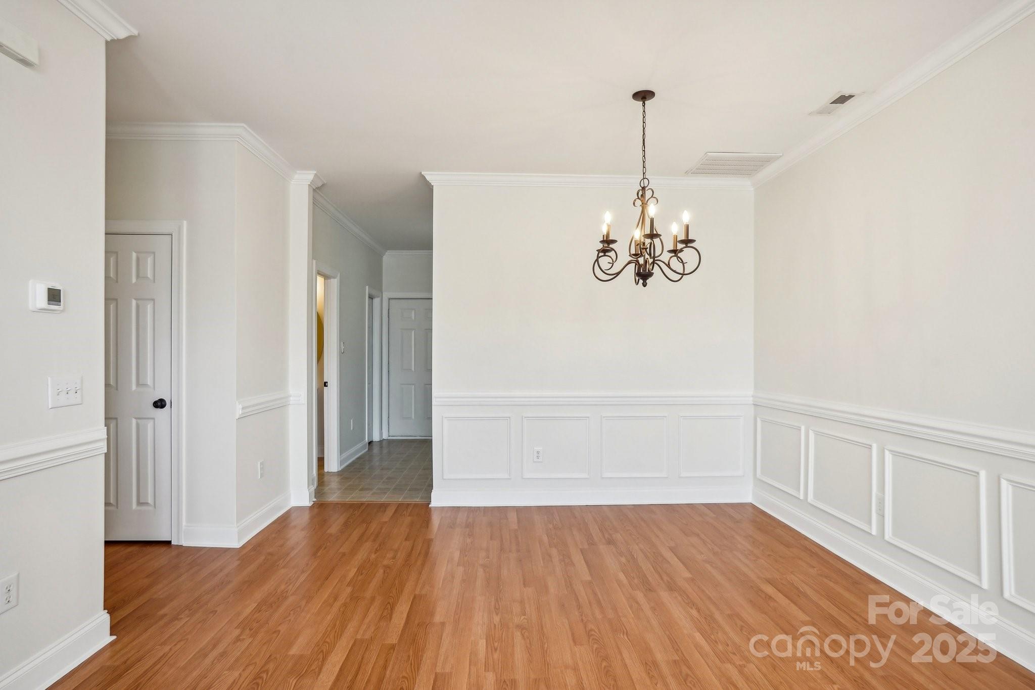 127 High Ridge Road Mooresville, NC 28117 - Photo 7 of 34 a view of a room with wooden floor chandelier and a window