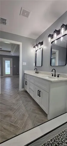 a view of an empty room with closet and wooden floor