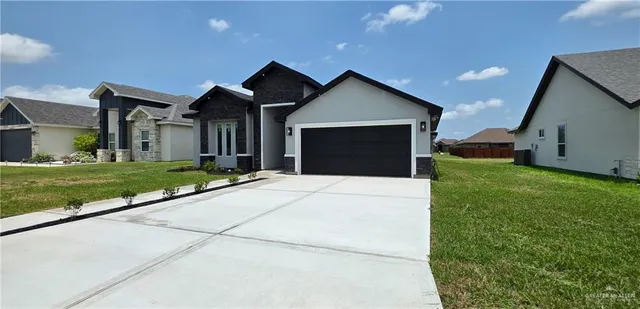 a front view of house with yard and green space