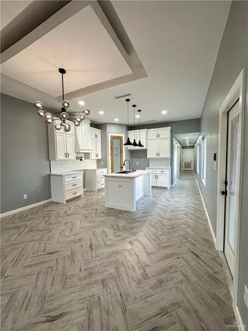 a view of a kitchen with a sink wooden floor and a kitchen