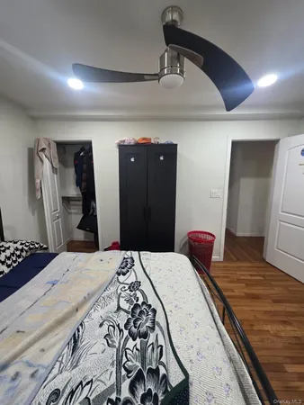 a bedroom with a large bed and a dresser