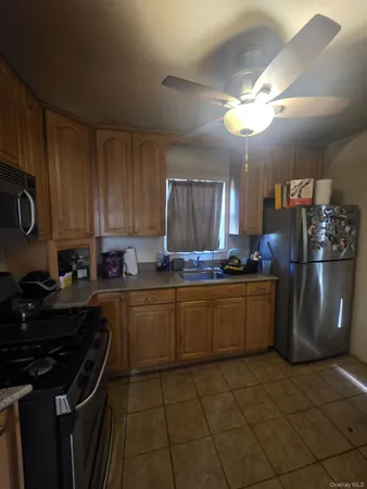 a kitchen with a stove cabinets and a refrigerator