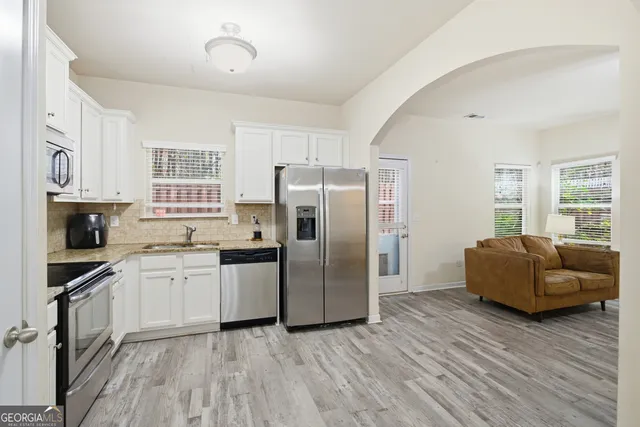 a view of a dining room with furniture and wooden floor