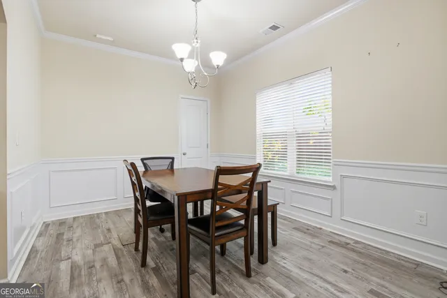 a view of a dining room with furniture window and wooden floor
