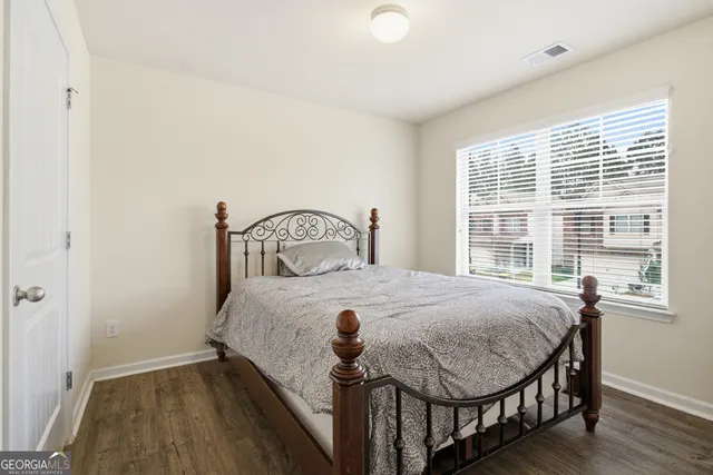 a bed room with a bed and a large window