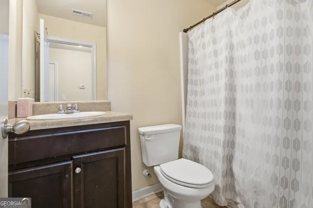 a spacious bedroom with a bed and a chandelier