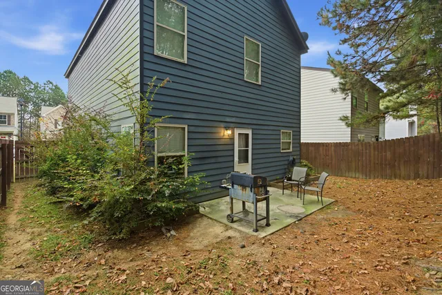 an aerial view of a house with garden space and swimming pool
