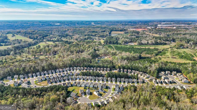 an aerial view of a house with swimming pool and a garden