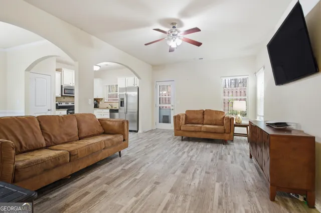 a living room with furniture and a flat screen tv