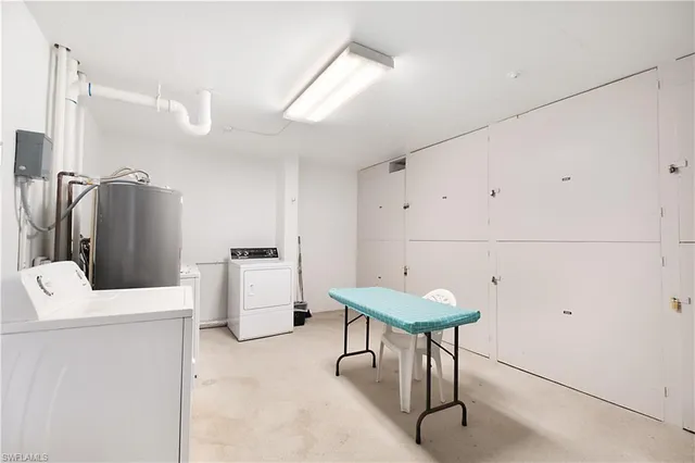 a kitchen with stainless steel appliances kitchen island a refrigerator and cabinets