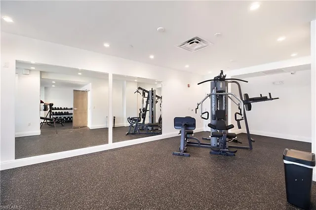 a group of palm trees in front of a building