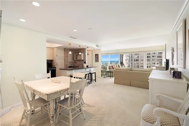 a living room with furniture and view of kitchen