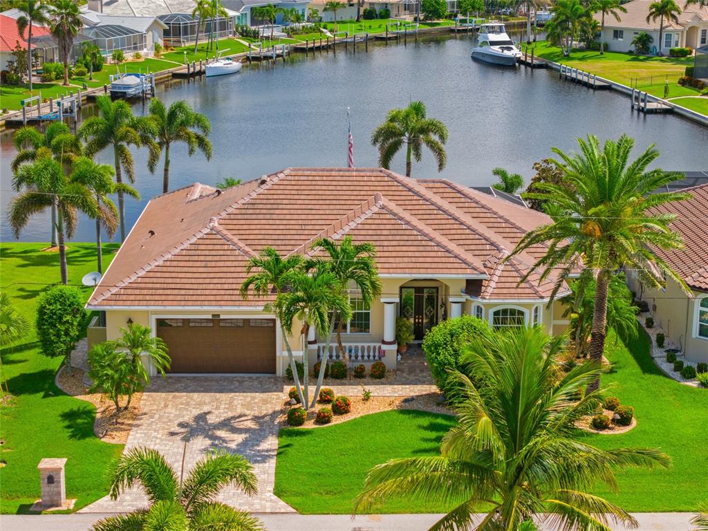 a front view of a house with garden and plants