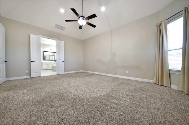 a spacious bathroom with a tub double sink and mirror