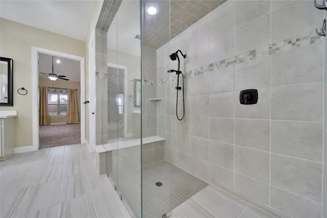 a bathroom with a bathtub a mirror a sink and a shower