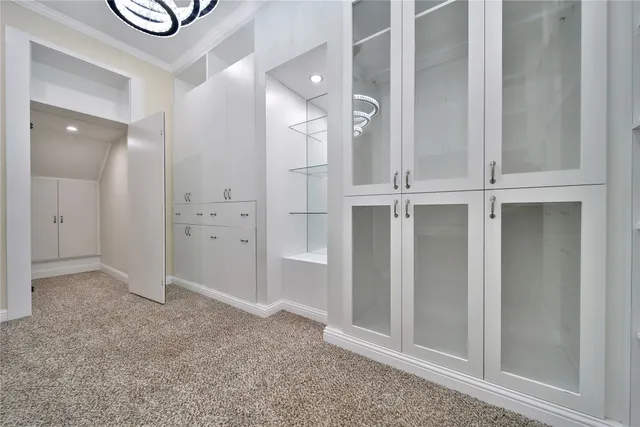 an empty room with closet and windows