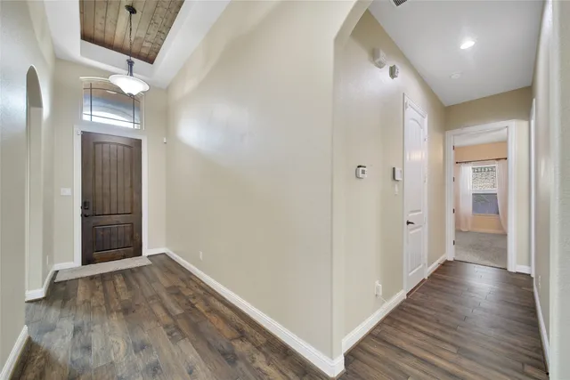 a view of staircase with wooden floor and fan