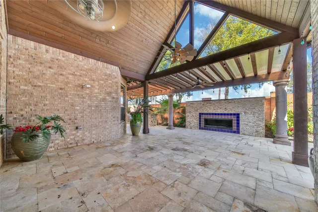 a view of a porch with furniture and a fireplace