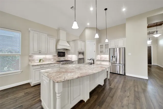 a kitchen with kitchen island a sink stove and wooden floor