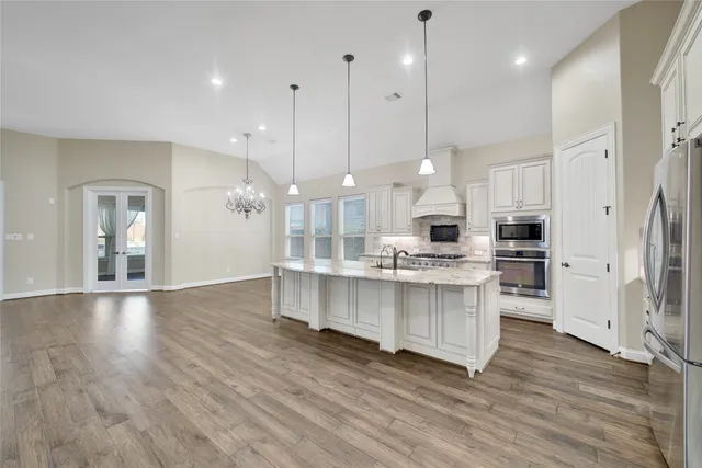 a large kitchen with stainless steel appliances kitchen island a large island in the center