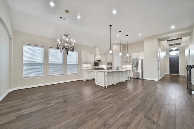 a view of kitchen with granite countertop cabinets and wooden floor
