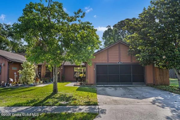 a front view of house with a yard and garage