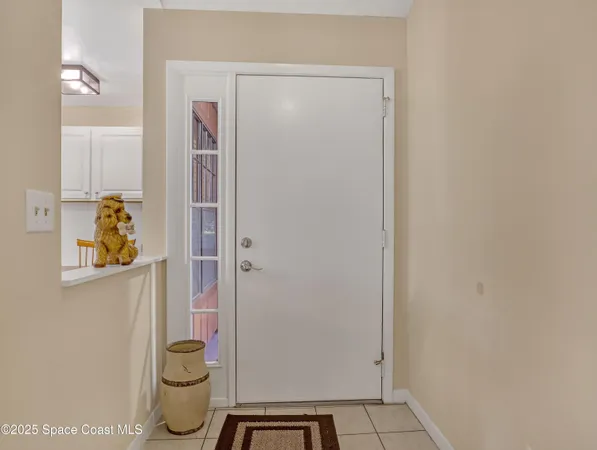 a view of a dining room with furniture a chandelier and window