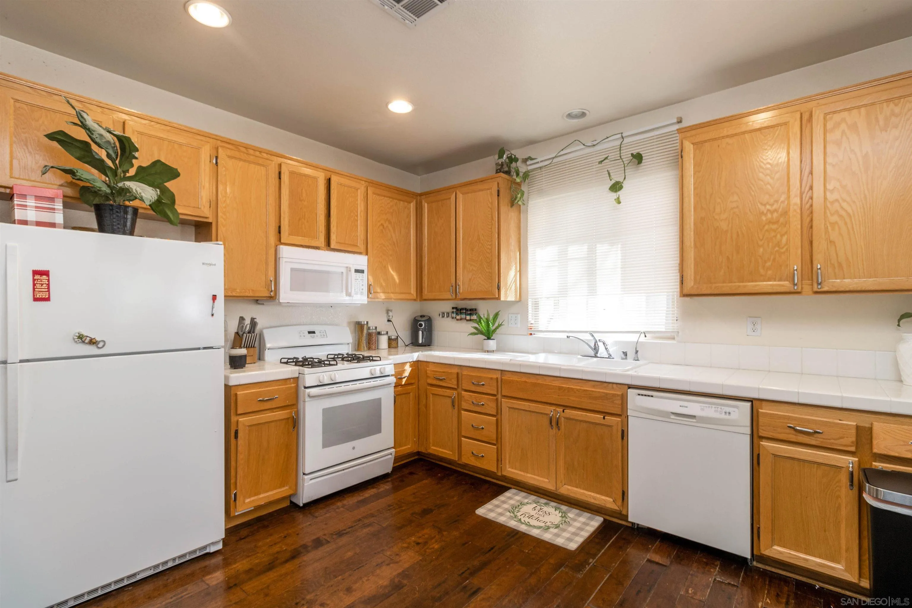 4046 Craven Road, Unit 42 Oceanside, CA 92057 - Photo 3 of 17 a kitchen with a white cabinets and white appliances