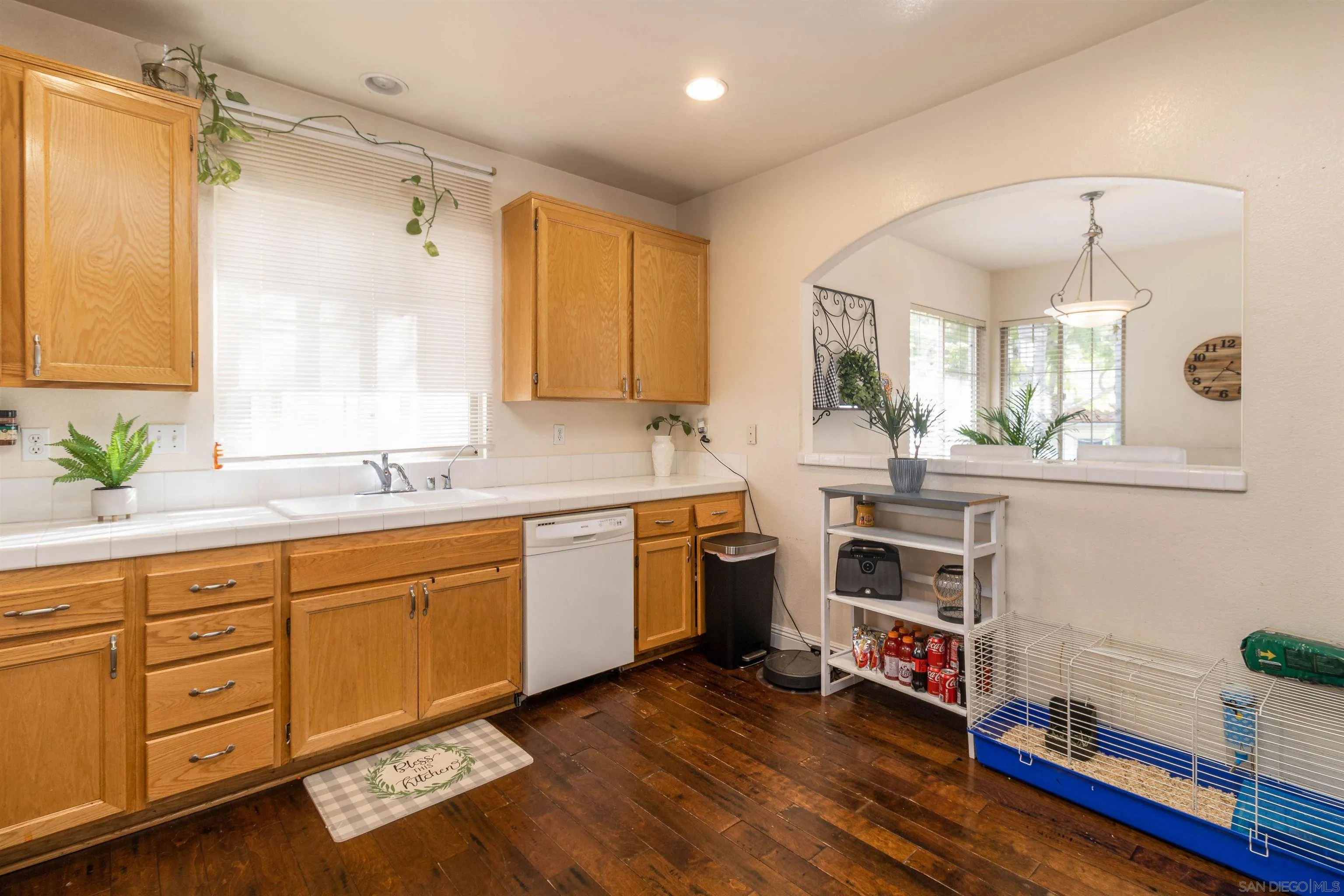 4046 Craven Road, Unit 42 Oceanside, CA 92057 - Photo 5 of 17 a kitchen with a sink cabinets and wooden floor