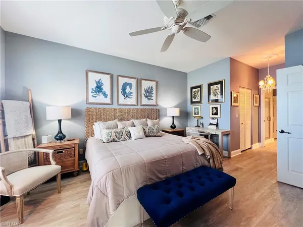 a bedroom with a bed and a chandelier