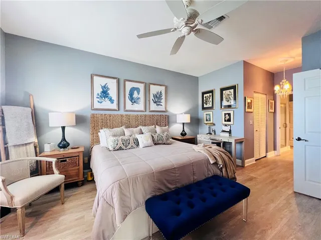 a bedroom with a bed and a chandelier