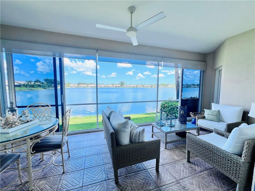 3250 West Crown Pointe Boulevard, Unit 101 Naples, FL 34112 - Photo 28 of 46 a living room with furniture and a floor to ceiling window