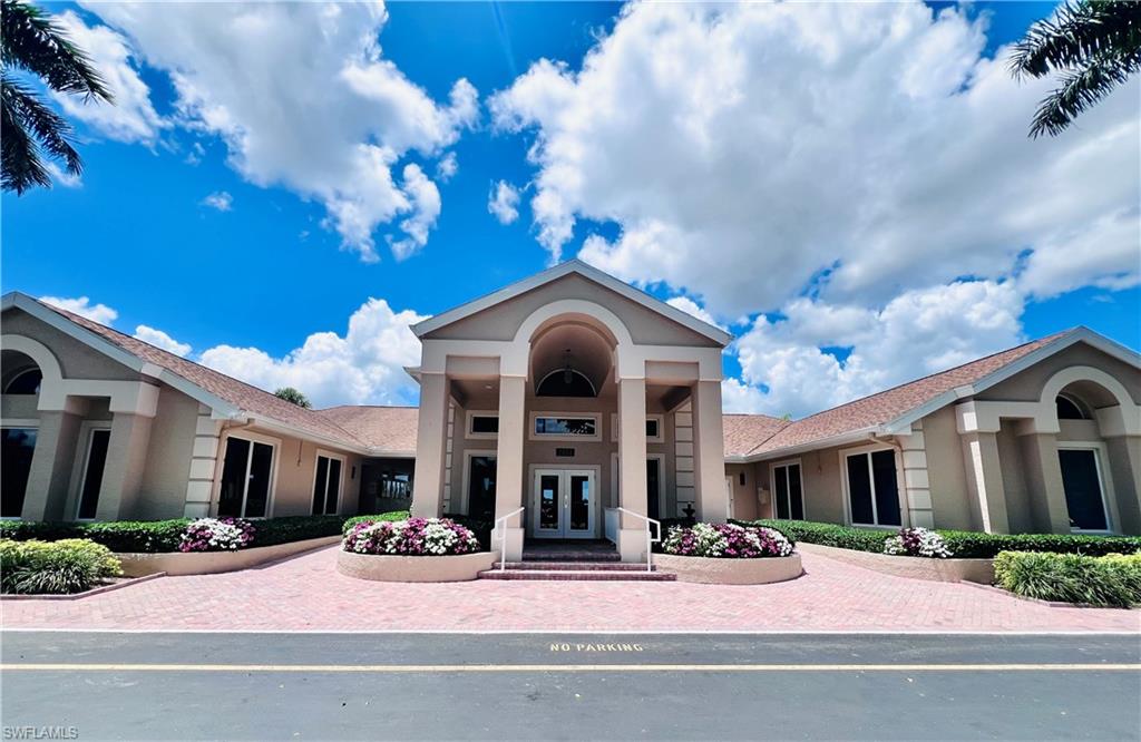 3250 West Crown Pointe Boulevard, Unit 101 Naples, FL 34112 - Photo 33 of 46 a view of a brick house with a large windows